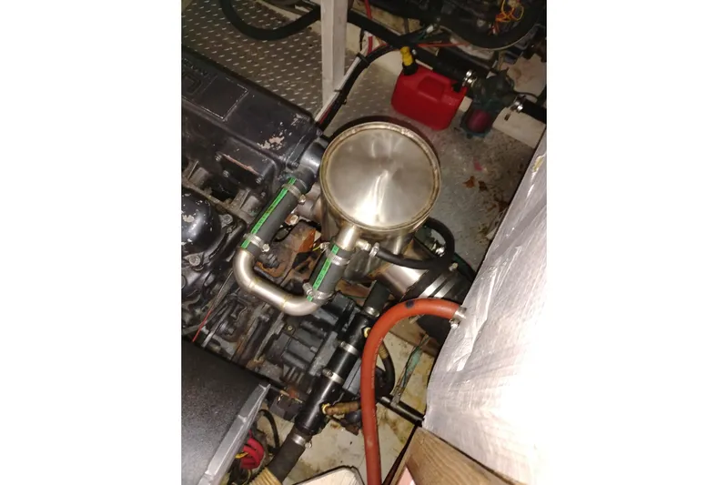 Slide: The Image of Engine compartment of a 1990 Bayliner 3888 Motoryacht, showing mechanical components and hoses. - 47