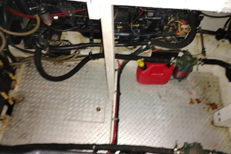 Slide: The Image of Engine room of 1990 Bayliner 3888 Motoryacht with visible hoses and equipment. - 48