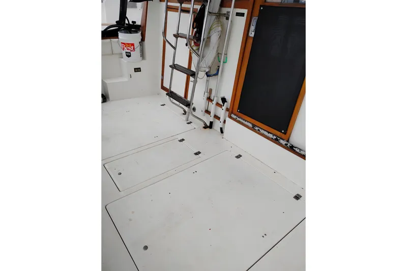 Slide: The Image of 1990 Bayliner 3888 Motoryacht deck with ladder and storage compartments. - 5