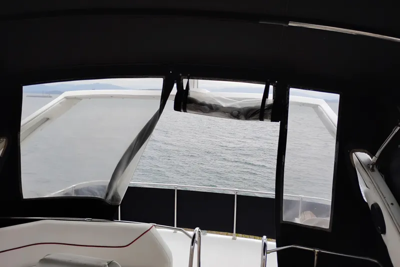 Slide: The Image of 1990 Bayliner 3888 Motoryacht interior view with ocean backdrop. - 7
