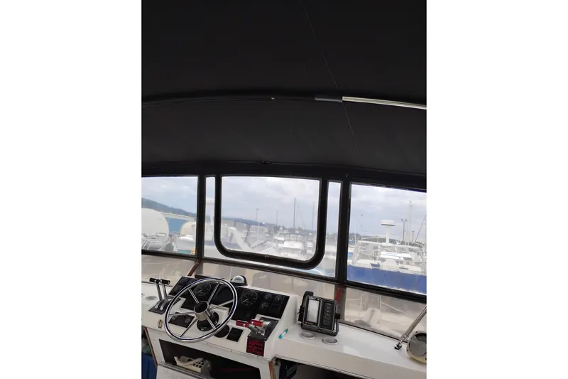 Slide: The Image of Interior view of 1990 Bayliner 3888 Motoryacht helm with steering wheel and navigation equipment. - 8