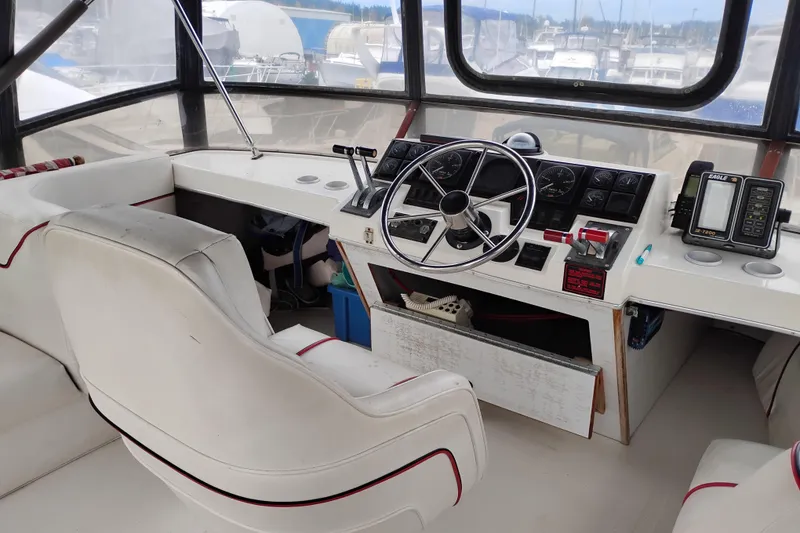 Slide: The Image of 1990 Bayliner 3888 Motoryacht helm with steering wheel, gauges, and navigation equipment. - 9