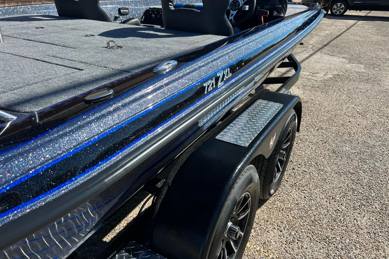 Slide: The Image of 2026 Phoenix 721 ZXL boat with glittery blue accents on a trailer. - 2