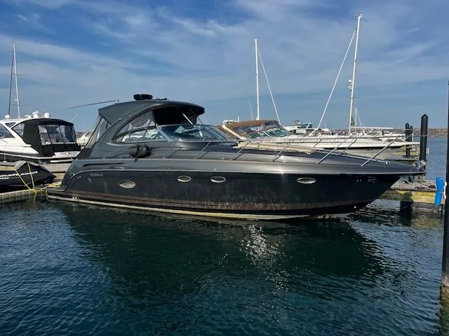 The Image of 2018 Formula 37 Performance Cruiser docked in a marina under a clear blue sky. - 0