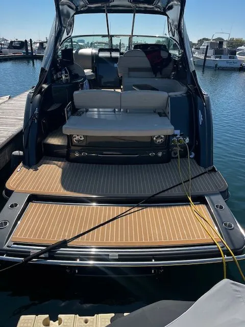 Slide: The Image of 2018 Formula 37 Performance Cruiser docked, showcasing spacious deck and seating area. - 2