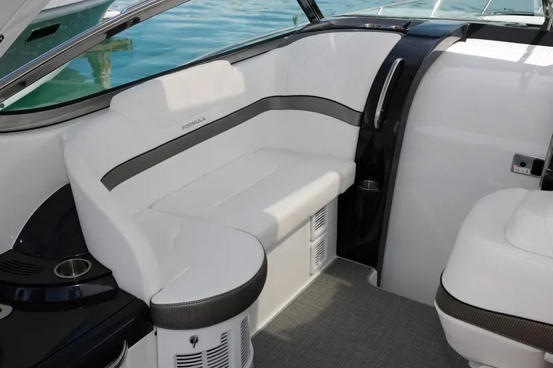 Slide: The Image of 2019 Formula 37 Performance Cruiser interior seating area with white and black upholstery. - 21