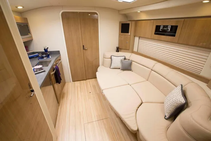 Slide: The Image of 2019 Formula 37 Performance Cruiser interior with beige leather seating and modern kitchen. - 28