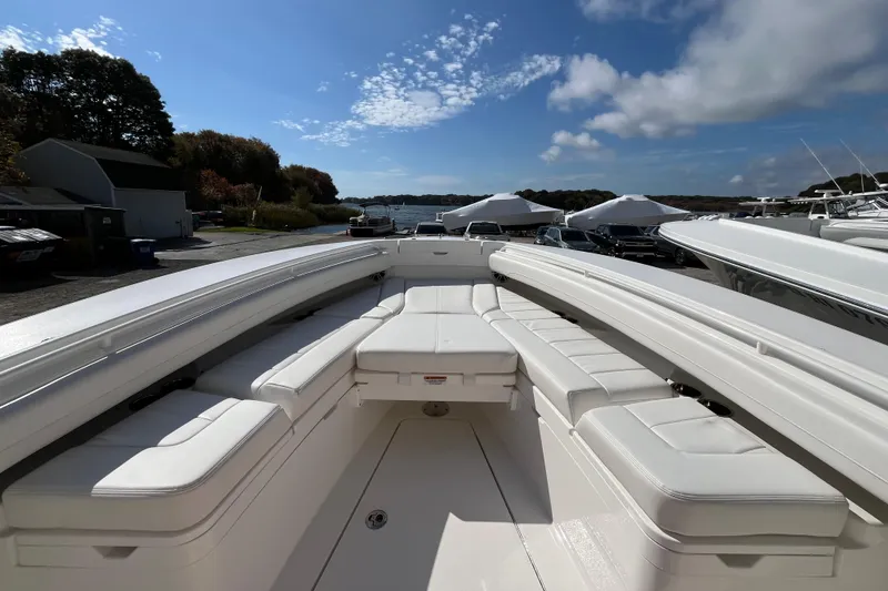 Slide: The Image of 2023 Regulator 28 boat with spacious seating, docked under a clear blue sky. - 15