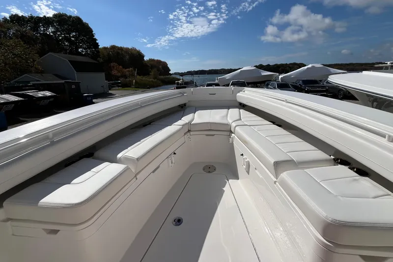 Slide: The Image of 2023 Regulator 28 boat with spacious white seating and clear blue sky. - 20