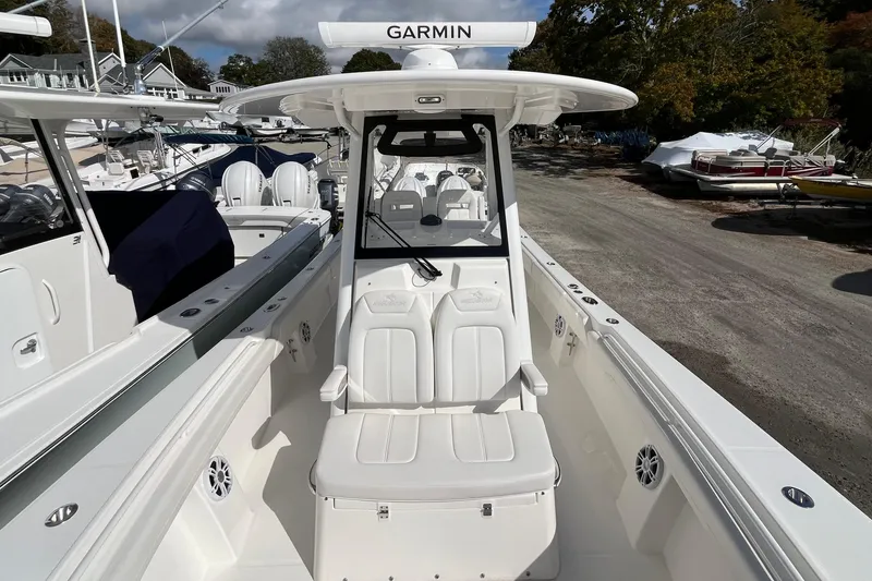 Slide: The Image of 2023 Regulator 28 boat with Garmin equipment, docked in a marina. - 22