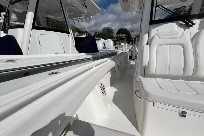 Slide: The Image of 2023 Regulator 28 boat interior with white seating and sleek design. - 25