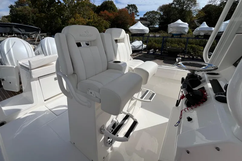 Slide: The Image of 2023 Regulator 28 boat interior with white seating and control panel. - 29