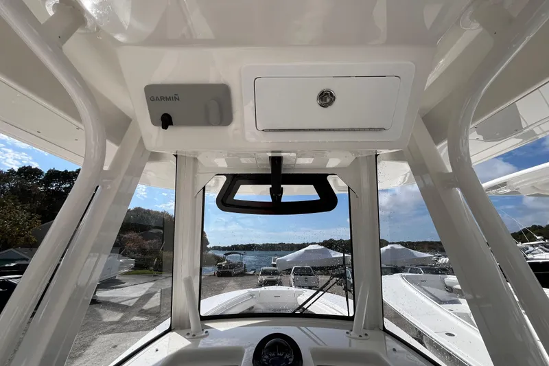 Slide: The Image of 2023 Regulator 28 boat interior with Garmin equipment, docked near a scenic waterfront. - 33