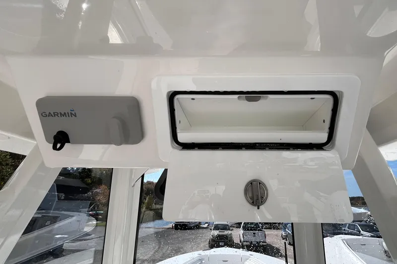 Slide: The Image of 2023 Regulator 28 boat console with Garmin device and storage compartment. - 34