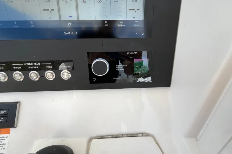 Slide: The Image of Control panel of 2023 Regulator 28 boat with Garmin and Fusion displays. - 37