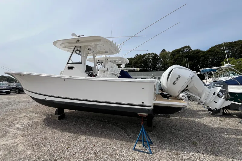 Slide: The Image of 2023 Regulator 28 boat with Yamaha engines on display outdoors. - 4