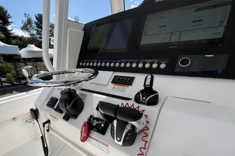 Slide: The Image of 2023 Regulator 28 boat dashboard with advanced controls and navigation screens. - 43