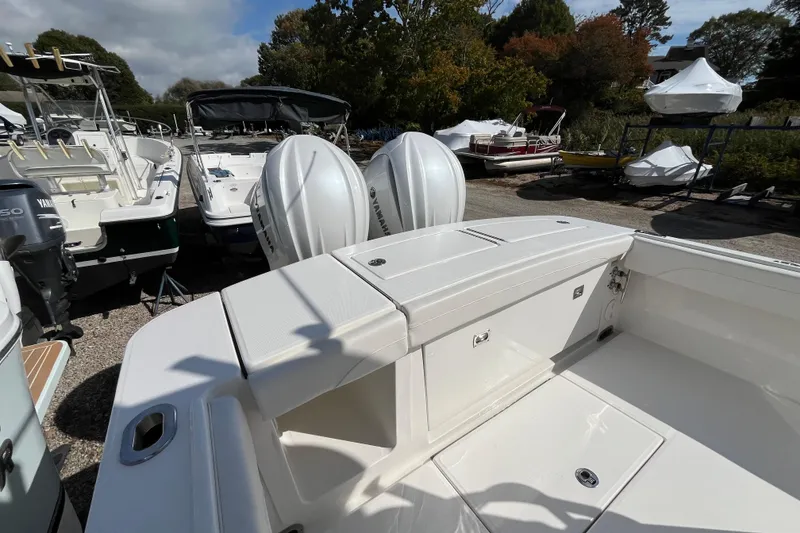 Slide: The Image of 2023 Regulator 28 boat with dual Yamaha outboard engines, docked outdoors. - 46