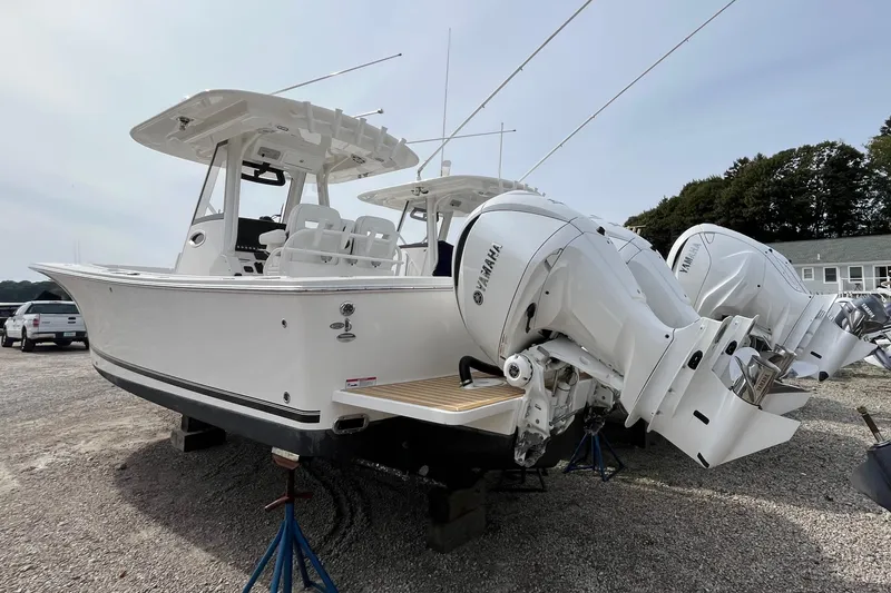 Slide: The Image of 2023 Regulator 28 boat with twin Yamaha engines on display outdoors. - 5