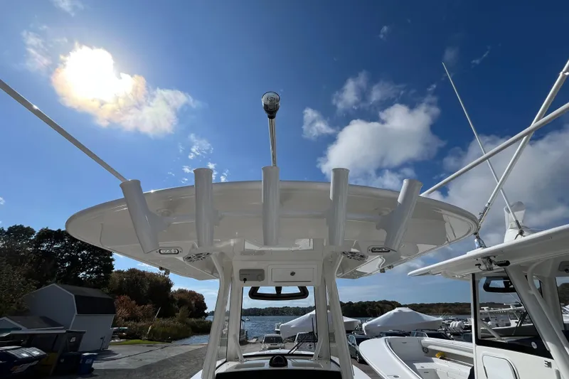 Slide: The Image of 2023 Regulator 28 boat with rod holders under a clear blue sky. - 50