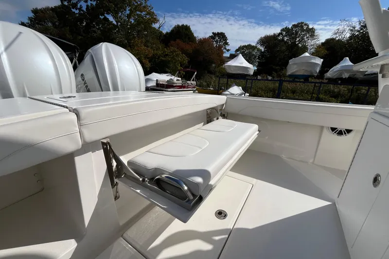 Slide: The Image of 2023 Regulator 28 boat interior with foldable seating and Yamaha engines in the background. - 52