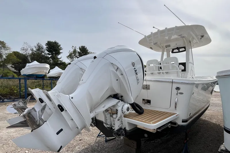 Slide: The Image of 2023 Regulator 28 boat with dual Yamaha outboard engines, docked outdoors. - 6