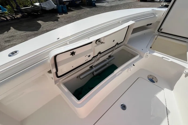 Slide: The Image of 2023 Regulator 28 boat storage compartment with open hatch, showcasing interior space. - 8