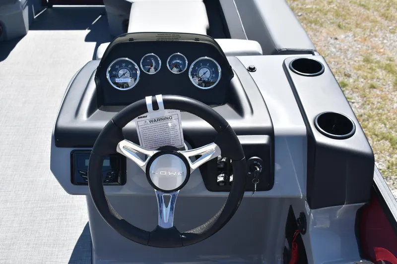 Slide: The Image of Steering console of 2025 Lowe LS 210 WT boat with gauges and cup holders. - 12