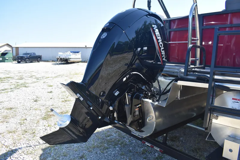 Slide: The Image of 2025 Lowe LS 210 WT boat with Mercury outboard motor in a gravel lot. - 13