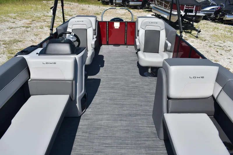 Slide: The Image of 2025 Lowe LS 210 WT pontoon boat interior with gray seating and steering console. - 15