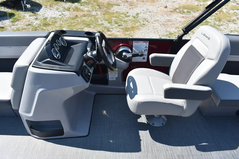 Slide: The Image of Interior of 2025 Lowe LS 210 WT boat with steering console and captain's chair. - 17