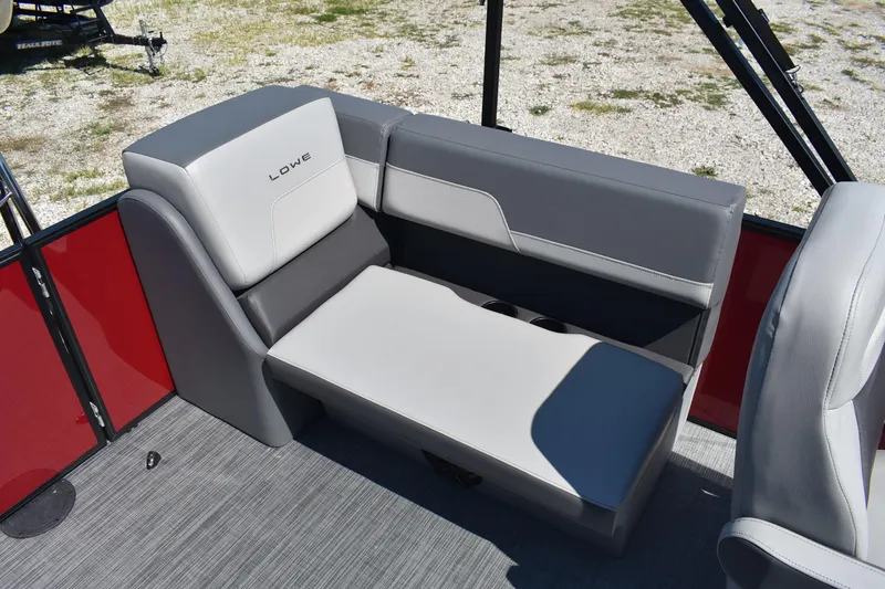 Slide: The Image of 2025 Lowe LS 210 WT boat interior with gray seating and red paneling. - 19