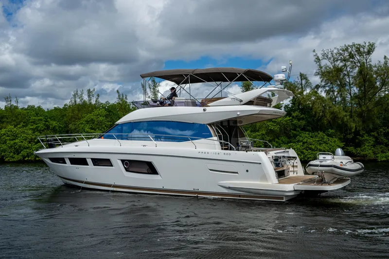 Slide: The Image of 2012 Prestige Flybridge yacht cruising on a scenic waterway. - 28