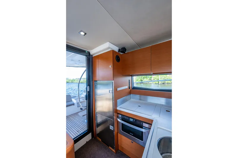 Slide: The Image of Interior of 2012 Prestige Flybridge yacht kitchen with modern appliances and scenic window view. - 42