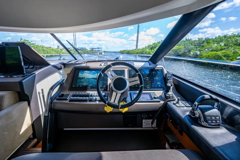 Slide: The Image of Cockpit of 2012 Prestige Flybridge yacht with modern navigation equipment and scenic waterway view. - 50