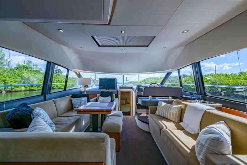 Slide: The Image of Luxurious interior of a 2012 Prestige Flybridge yacht with plush seating and panoramic windows. - 54
