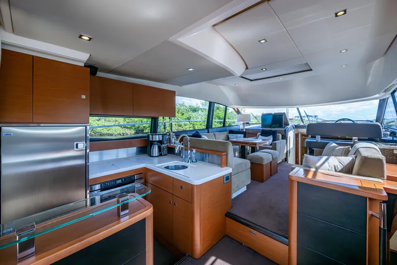 Slide: The Image of Luxurious interior of a 2012 Prestige Flybridge yacht with modern kitchen and seating area. - 57