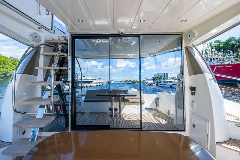 Slide: The Image of Luxurious 2012 Prestige Flybridge yacht interior with glass doors and marina view. - 58