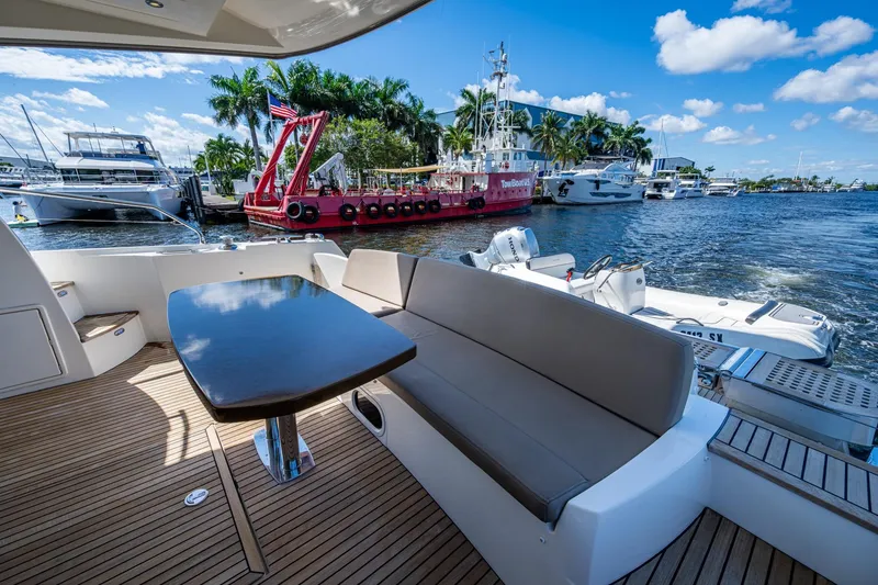 Slide: The Image of Luxurious 2012 Prestige Flybridge yacht with elegant seating, docked by scenic waterfront. - 59