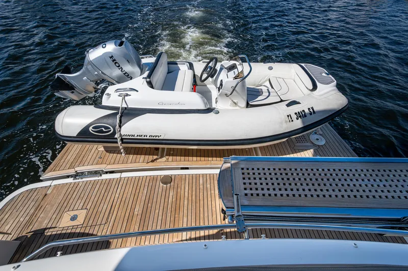 Slide: The Image of 2012 Prestige Flybridge yacht with Walker Bay tender on wooden deck. - 64
