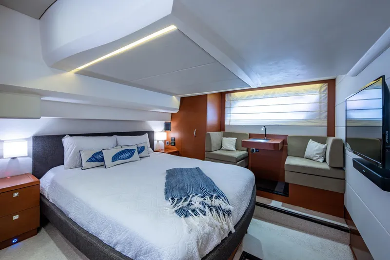 Slide: The Image of Luxurious 2012 Prestige Flybridge yacht bedroom with modern decor and cozy seating area. - 80
