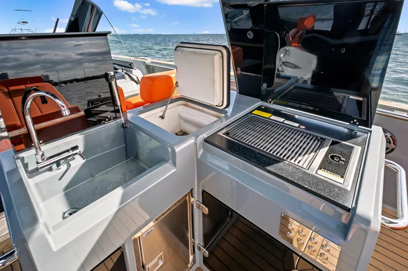 Slide: The Image of Outdoor kitchen on 2019 Fjord 52 Open yacht with sink, grill, and storage. - 11