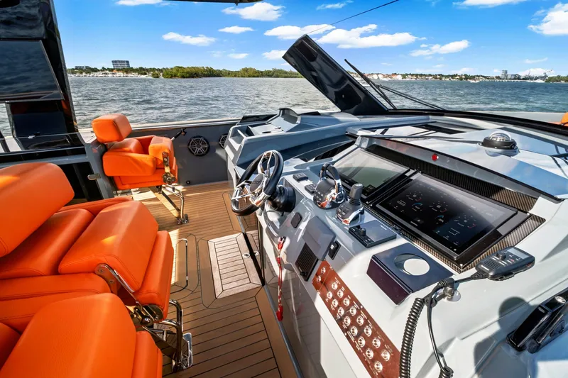 Slide: The Image of Luxurious 2019 Fjord 52 Open yacht cockpit with orange seating and advanced navigation controls. - 13
