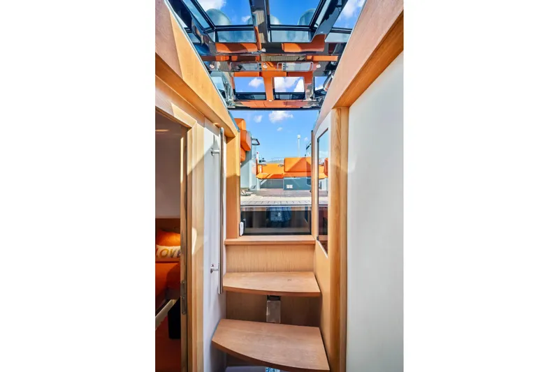 Slide: The Image of Interior view of 2019 Fjord 52 Open yacht with wooden stairs and glass ceiling. - 17