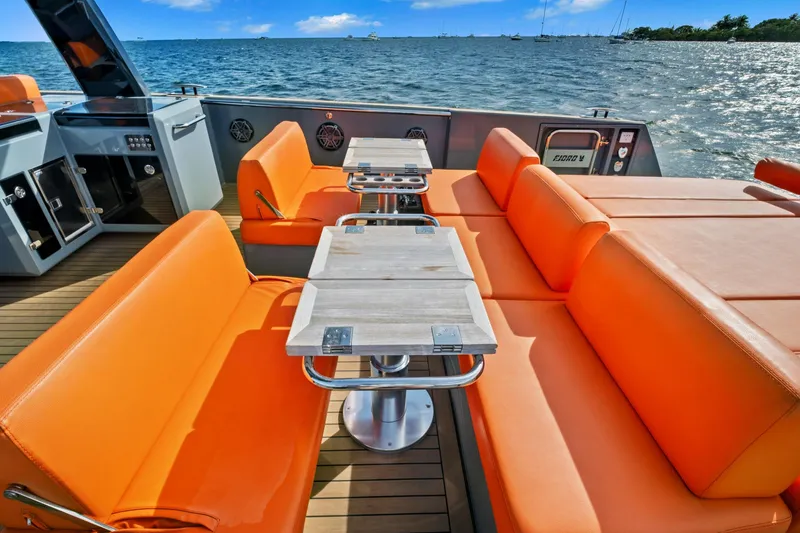 Slide: The Image of Luxurious 2019 Fjord 52 Open yacht with vibrant orange seating and ocean view. - 4