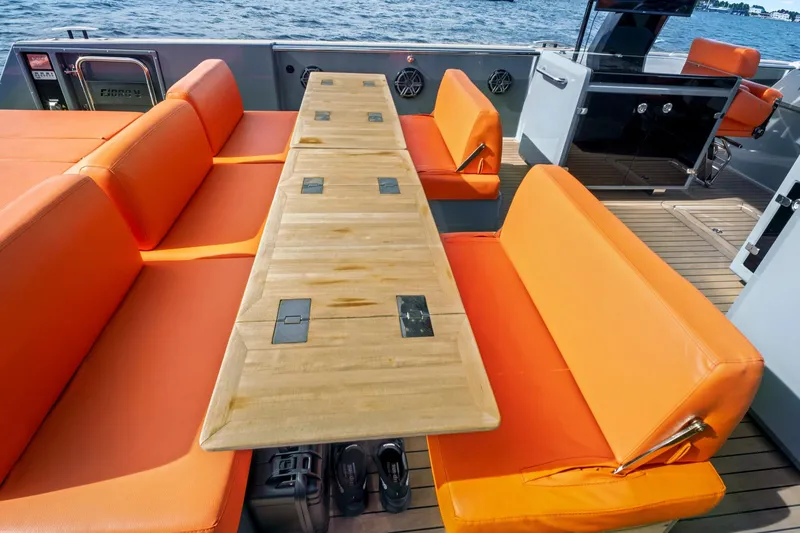 Slide: The Image of Luxurious 2019 Fjord 52 Open yacht with vibrant orange seating and wooden table. - 5