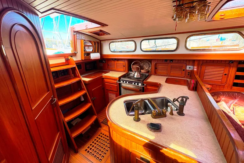Slide: The Image of Interior of 1987 Hans Christian Cristina 40 yacht with wooden cabinetry and kitchen amenities. - 12