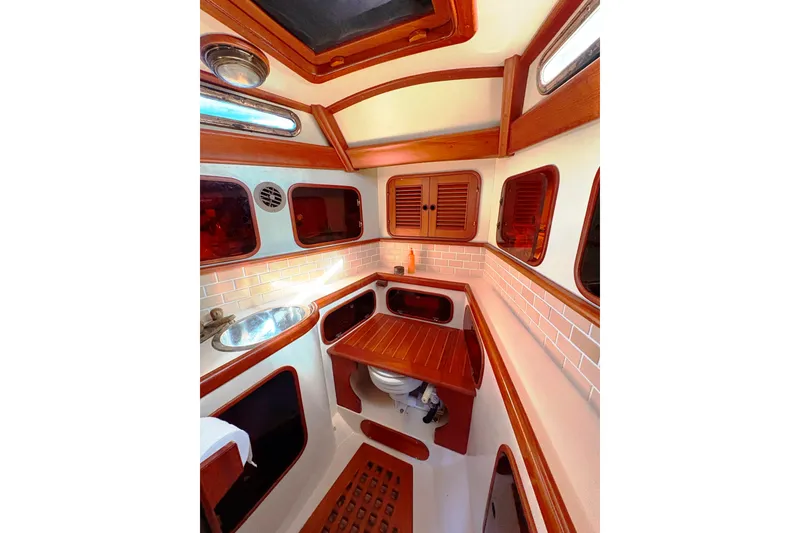 Slide: The Image of 1987 Hans Christian Cristina 40 yacht interior with wooden cabinetry and compact sink. - 17