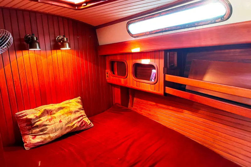 Slide: The Image of Cozy cabin interior of 1987 Hans Christian Cristina 40 sailboat with warm wood paneling. - 18
