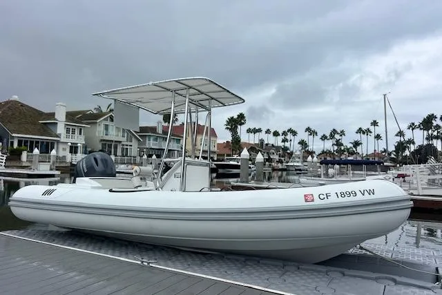 Slide: The Image of 2023 Novurania Como 18 boat docked in a marina with overcast skies. - 20